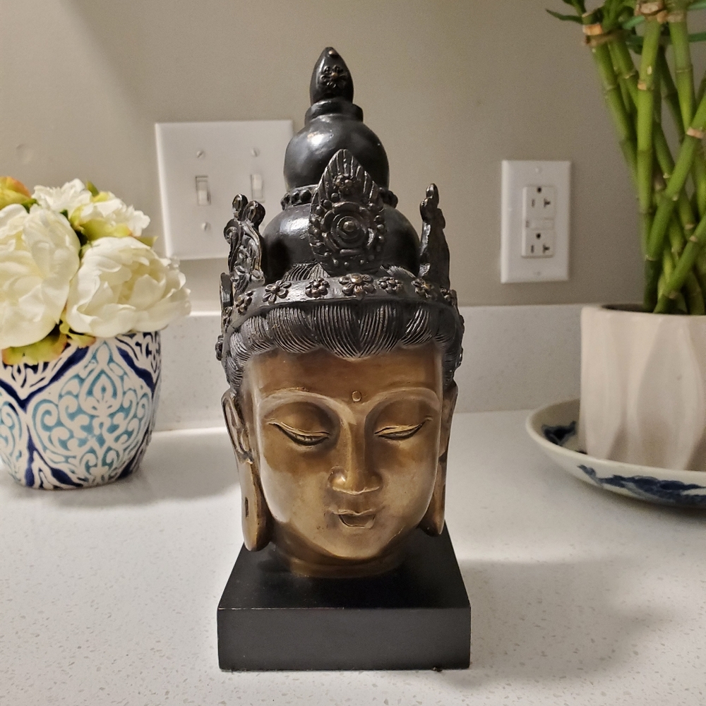 Vintage Buddha head on a stand. Cast metal with a bronze finish.